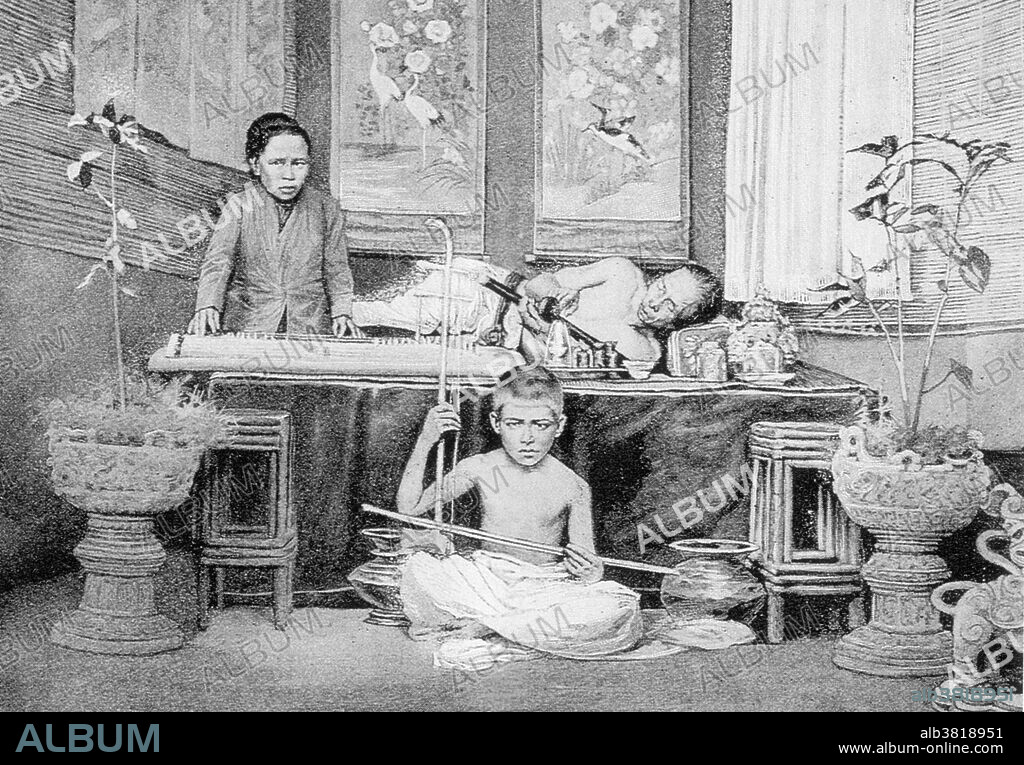 An opium den in China. The original caption from this 1899 photograph reads "Rich people have everything in their houses, including a room where they can close themselves up and surrender to their degrading and fatal vice." The woman and the boy soothe the smoker with music while he prepares his own pipes. Opium is a narcotic drug obtained from the seeds of the opium poppy. It contains the chemicals morphine and codeine, as well as other alkaloids. The opium resin from the poppy is processed, and then burned in pipes. The smoker inhales the vapors from the burning resin. Opium is an addictive drug. In the 19th century and the early 20th century, opium smoking was common worldwide, especially in Asia, which was one of the sources of the opium poppy. There were many opium dens where such smoking took place.