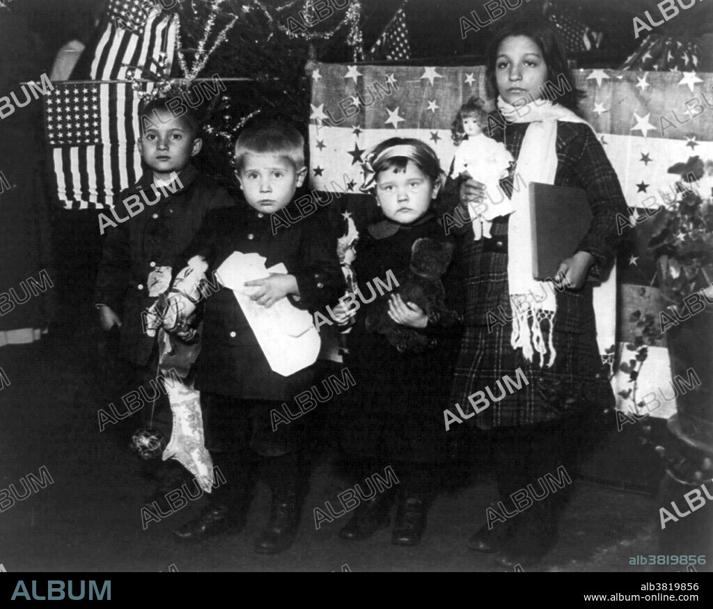 Their first Xmas in America, Ellis Island. construct America's first Federal immigration station on Ellis Island. The present main structure was designed in French Renaissance Revival style and built of red brick with limestone trim. When it opened on December 17, 1900, officials estimated 5,000 immigrants per day would be processed. By the time it closed on November 12, 1954, 12 million immigrants had been processed by the U.S. Bureau of Immigration. Today, over 100 million Americans, one third of the population, can trace their ancestry to the immigrants who first arrived in America at Ellis Island before dispersing to points all over the country. Photographed by Paul Thompson, December 1918.