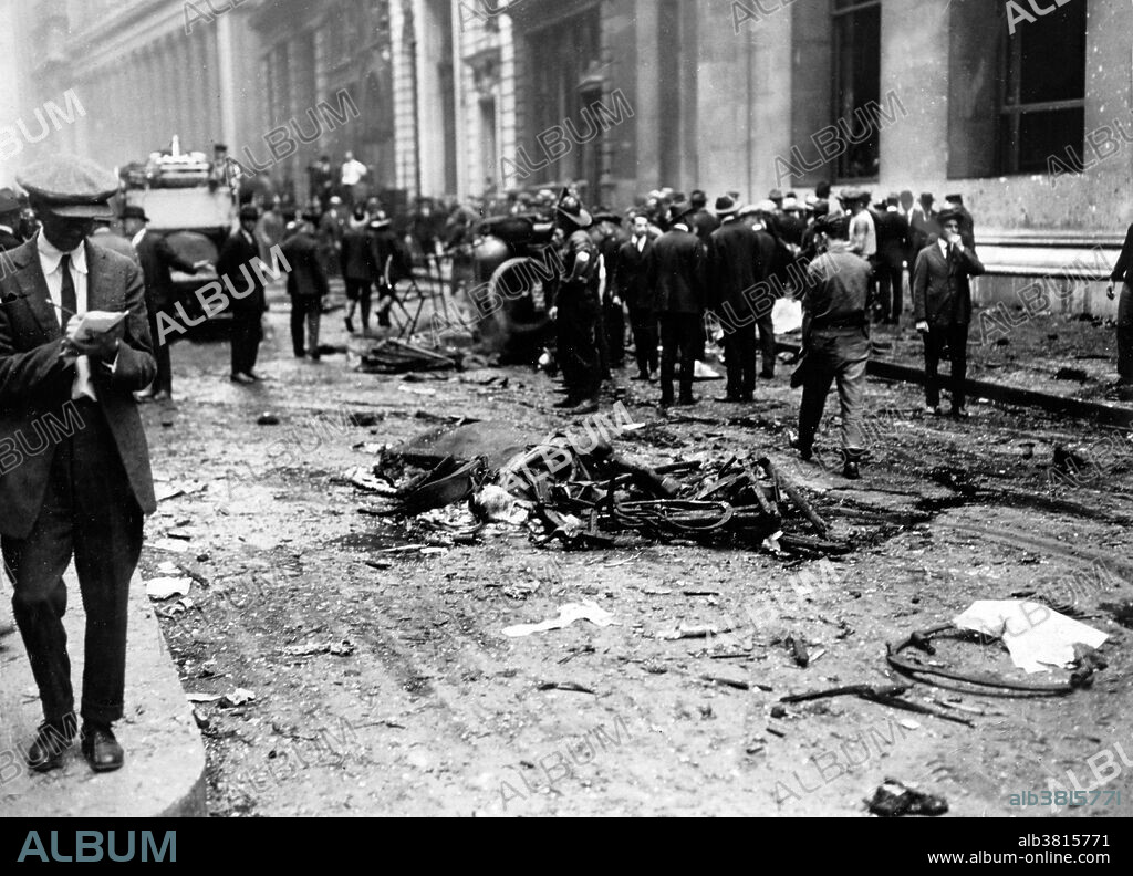 Entitled: "Crowd gathered behind a dead horse after the Wall Street explosion." On September 16, 1920, a horse drawn wagon stopped across the street from the headquarters of the J.P. Morgan bank at 23 Wall Street. Inside the wagon, 100 lbs of dynamite with 500 lbs of cast-iron sash weights exploded in a timer-set detonation. The horse and wagon were blasted into small fragments, but the driver was believed to have left the vehicle and escaped. The 38 victims, most of whom died within moments of the blast, were mostly young people who worked as messengers, stenographers, clerks, and brokers. The bomb caused more than $2 million in property damage ($23,500,000 with inflation) and destroyed most of the interior spaces of the Morgan building. There were 143 seriously injured, and the total number of injured was in the hundreds. The bombing was never solved, although investigators and historians believe the Wall Street bombing was carried out by Italian anarchists, a group responsible for a series of bombings the previous year. Photographed by the New York World-Telegram and the Sun Newspaper, 1920.