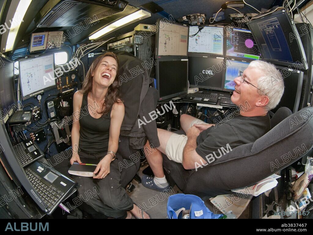Scientist Karen Kosiba and Doppler on Wheels inventor Joshua Wurman enjoy a lighter moment inside the control room of the portable weather radar truck on May 29, 2010. The DOW is one of several research vehicles that participated in VORTEX 2, an unprecedented two-year science project to study tornadoes in the United States in 2009 and 2010.
