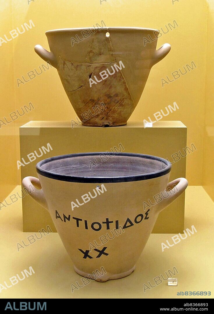 Greece: Two ancient Greek outflow water clocks (clepsydra) from the 5th century BCE, Ancient Agora Museum, Athens.<br/><br/>. A water clock or clepsydra is any timepiece by which time is measured by the regulated flow of liquid into (inflow type) or out from (outflow type) a vessel, and where the amount is then measured.