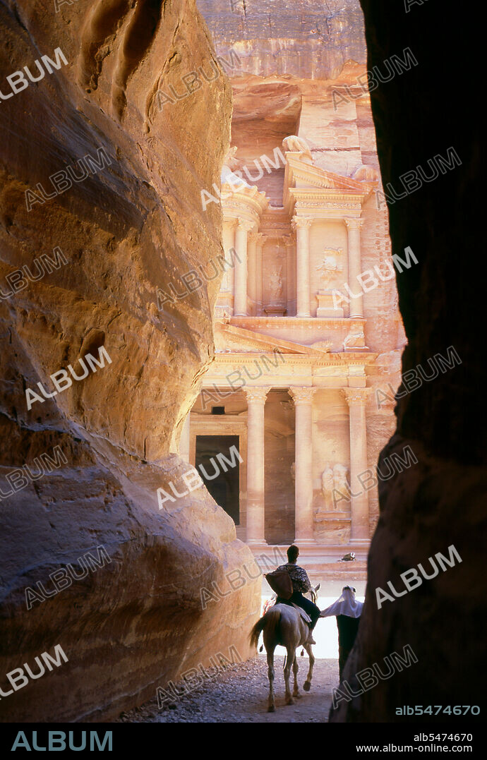 The Siq or al-Siq (translated: the shaft) is the main entrance to the ancient city of Petra in southern Jordan. The dim, narrow gorge (in some points no more than 3 meters wide) winds its way approximately one mile and ends at Petra's most elaborate ruin, Al Khazneh (The Treasury). Petra was first established as a city by the Nabataean Arabs in the 4th century BCE, and owed its birth and prosperity to the fact that it was the only place with clear and abundant water between the Hijaz trading centres of Mecca and Medina, and Palestine. Hewn directly into the Nubian sandstone ridges of the south Jordanian desert, it seems probable that - given its excellent defensive position and good water supplies - Petra has been continually occupied from as early as Paleolithic times. It is thought to be mentioned in the Bible as Sela, a mountain fortress captured by Amaziah, King of Judah, in the 9th century BC, when the defenders were hurled to their deaths from the summit, and as many as 10,000 people died. The city's Latin name, Petra - literally, 'Rock' - probably replaced the biblical name Sela at the time of the Roman conquest some 1,900 years ago. Today, in Arabic, the ancient site is still called Batraa, though the valley in which it is situated is known as Wadi Musa - 'The Valley of Moses' - being one of the places where, according to semitic tradition, the Prophet Moses struck a rock and water gushed forth. Truly Petra is steeped in history.