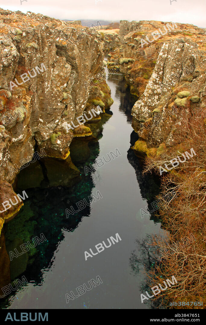 Volcanic rift zone. Iceland is the largest volcanic island on Earth and is sliced down the middle by the hot, geologically active Mid-Atlantic Ridge. This unique placement marks the boundary of the American Tectonic Plate and the Eurasian Tectonic Plate. As these plates spread, lava reaches Earth's surface, and Iceland's volcanoes are born.