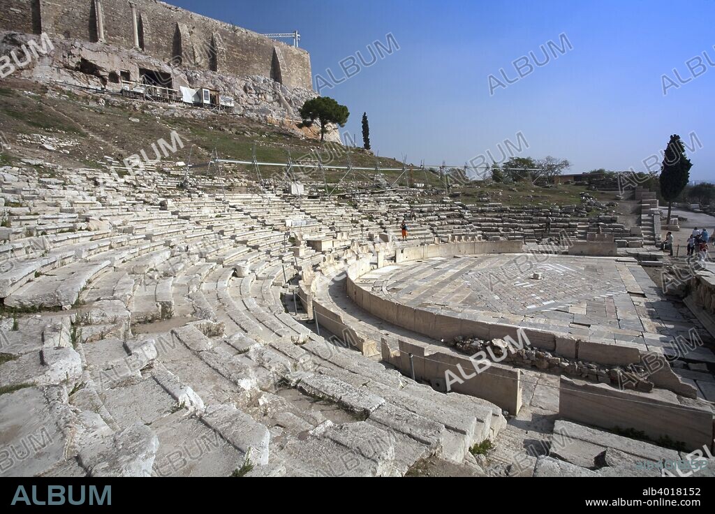 The Theatre of Dionysus, The Acropolis, Athens, Greece. The Theatre of Dionysos is the oldest of the three architectural complexes on the southern slopes of the Acropolis (the others being the Odeion of Herodes Atticus and the Stoa of Eumenes). In the sixth century BC, Peisistratos transferred the cult of Dionysos from Eleutherai in the Kithairon hills (on the old road to Thebes) to Athens, where accordingly the god was known as Dionysos Eleuthereus, and a temple was built to house the old cult image from Eleutherai. In association with the cult of Dionysos - the god of drunkenness, of transformation, of ecstasy and the mask - the Theatre of Dionysos was built in a natural hollow on the slopes of the Acropolis.