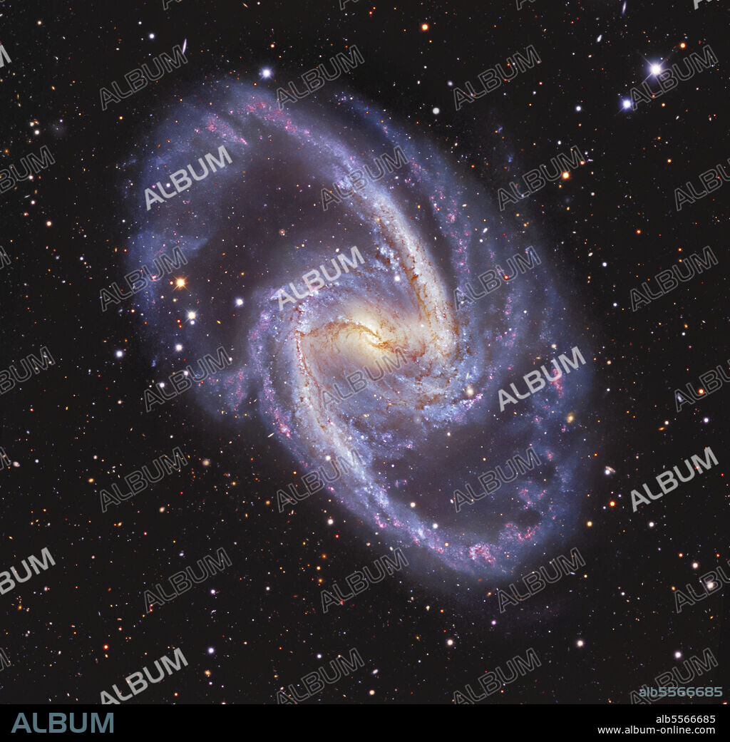 NGC 1365, double-barred spiral galaxy in the constellation Fornax. This image shows the galaxy's prominent bar and its graceful spiral arms, with lanes of dust obscuring the extended diffuse glow of stars. The central bar of NGC 1365 influences star formation throughout the entire galaxy and conceals a supermassive black hole hidden behind multitudes of newly formed stars.