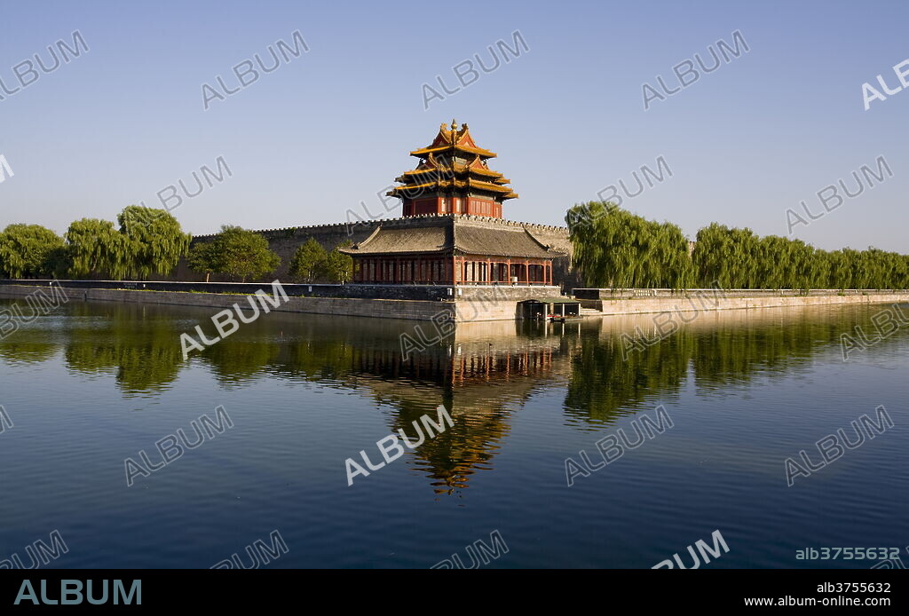 The northwest corner tower and water filled moat surrounding The Forbidden City, Beijing, China, Asia.