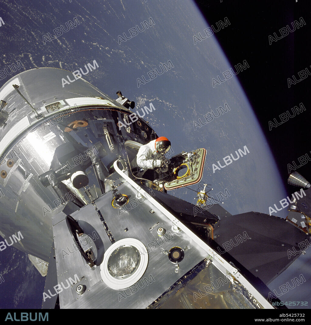 RUSSELL SCHWEICKART. Gumdrop Meets Spider, 1969. Apollo 9 Command/Service Modules (CSM) nicknamed "Gumdrop" and Lunar Module (LM), nicknamed "Spider" are shown docked together as Command Module pilot David R. Scott stands in the open hatch. Astronaut Russell L. Schweickart, Lunar Module pilot, took this photograph of Scott during his EVA as he stood on the porch outside the Lunar Module. Apollo 9 was an Earth orbital mission designed to test docking procedures between the CSM and LM as well as test fly the Lunar Module in the relative safe confines of Earth orbit.