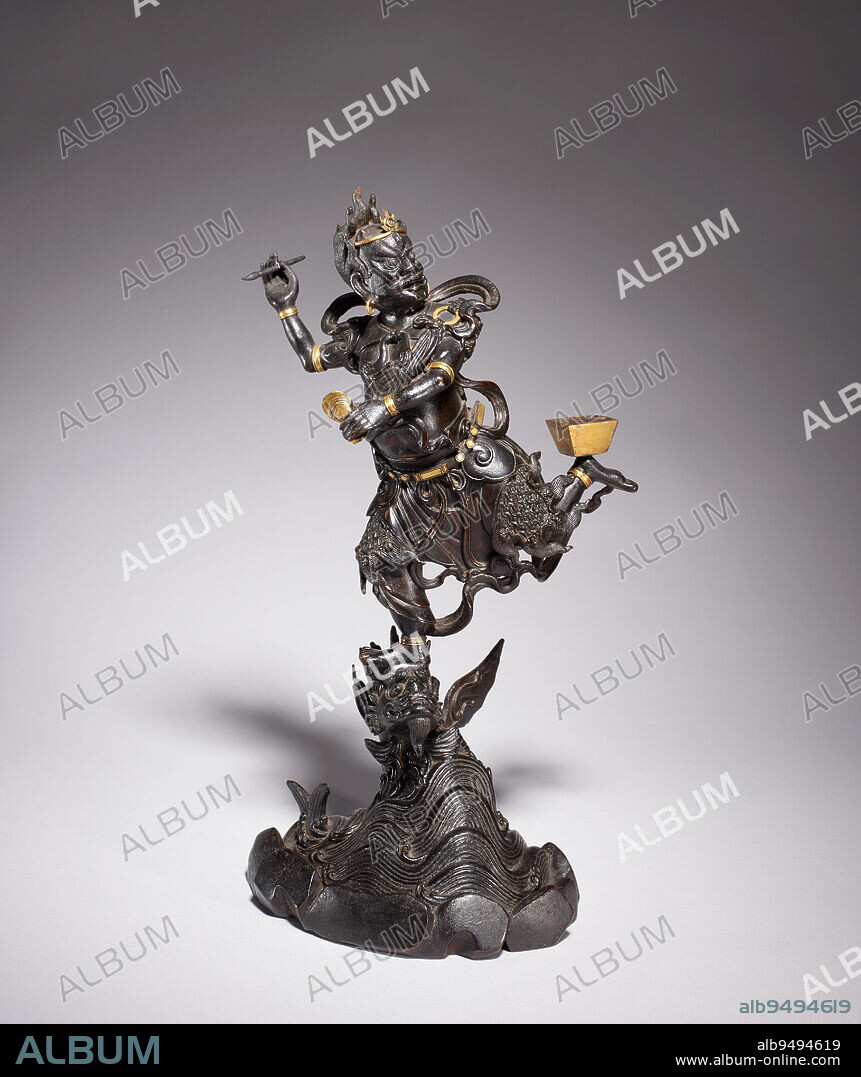 Kui Xing (God of Literature), 16th century, 25 x 7 x 5 in. (63.5 x 17.78 x 12.7 cm) (approximate), Bronze with traces of gilding, China, 16th century, Originating as a Daoist deity associated with the constellation Ursa Major, Kui Xing (also called Wen Chang and Wen Di) is worshipped in the third and eighth months as the God of Literature and patron saint of scholars. The surly-looking divinity is represented holding a brush in his right hand while standing on the head of a large fish becoming a dragon. The transformation of a carp into a dragon was a synonym for the literary success of an industrious student. This image holds a cap won by the chief graduate in his left hand while balancing a brushwasher on the heel of his upturned foot. Within Confucian society, scholarship could be the main determinant of one's rank and social status. The Chinese evolved a variety of so-called 'household gods' to help them attain wealth, health, long life, and martial prowess. Statues representing the god of literature would have been owned by all manner of literary persons: students, calligraphers, government officials, and writers.