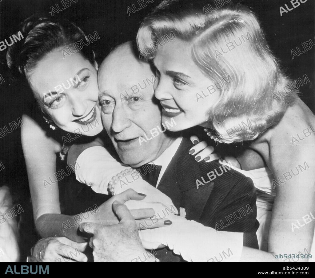 Movie Pioneer's Reward - Adolph Zukor, 80 years old yesterday and still an active leader in the film industry, gets birthday hugs from Dorothy Lamour (left) and Lizabeth Scott as he "starred" at a film industry dinner last night celebrating his birthday and his forthcoming 50th anniversary as a film producer. More than a thousand film town notables attended, including many whose movie careers he launched. Zukor, board chairman of Paramount Pictures, says he has no plans to retire. Party Hug: Doro.