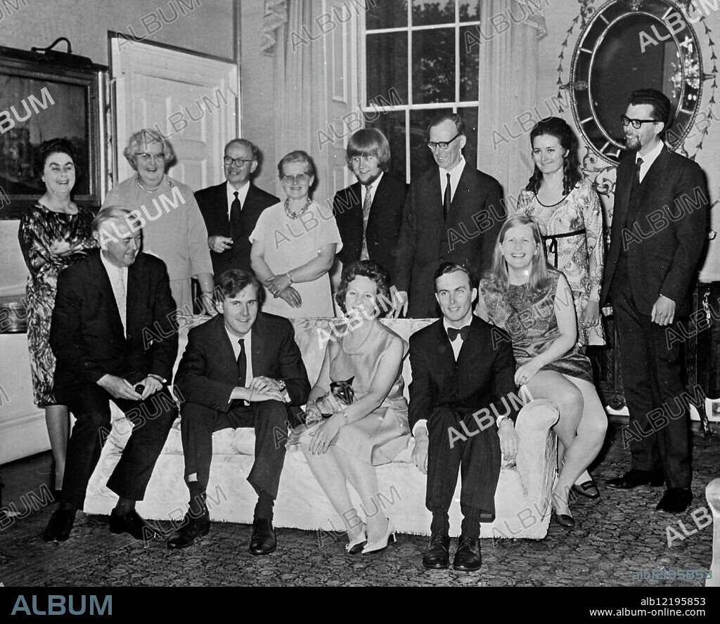 Giles Wilson, younger son of British Prime Minister Harold Wilson celebrated his 21st Birthday with a party at No10 Downing Street, London, on 10 May 1969. Seen here at the party in a family group marking another milestone in the family album are LtoR on settee: Mr Harold Wilson; Giles Wilson; Mrs Mary Wilson, with cat Nemo on her lap; Robin Wilson, the Premier's eldest son, and his wife, formerly Joy Crispin. Standing LtoR: Mrs Baldwin, a relative of Mrs Wilson; Miss Marjorie Wilson; Mr Crispin and his wife parents of Mrs Robin Wilson; Peter Crispin, their son; Professor Clifford Baldwin; Miss Pamela Tomkinson and Mrs John Baldwin. 12 May 1969.