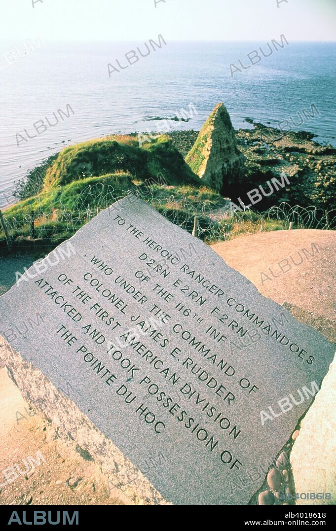 War memorial at the Pointe Du Hoc near Omaha Beach, Normandy, France. On June 1944 the American 2nd Ranger Battalion commanded by Lieutenant Colonel James E Rudder scaled the 100 foot high cliff of the Pointe du Hoc, taking it from the defending Germans and holding it against repeated counter-attacks despite suffering heavy casualties. The operation was vital to the success of the landings on Omaha Beach as the Germans had sited artillery on the clifftop overlooking the landing areas on the beach below. The inscription on the memorial reads: "To the heroic Ranger commandoes D2RN E2RN F2RN of the 116th Inf who under the command of Colonel James E Rudder of the First American Division attacked and took possession of the Pointe du Hoc".