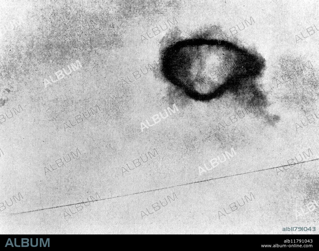 On 3rd August 1965, Rex Heflin took three photographs of a UFO, using a Polaroid camera, through the windscreen of his truck (he was a highway traffic inspector) near Santa Ana, California, USA. A fourth photograph shows a smoke ring which the UFO allegedly left when it departed. Investigators claim that this case is a hoax, the UFO being a model on a string.- ©TopFoto / Fortean.