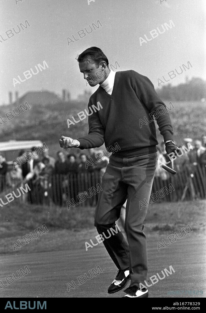 Ken Still (USA) sinks putt at the 14th green here yesterday , during the morning Singles Ryder Cup Match against Maurice Bembridge (GB) . Bembridge won the match by one hole . The match was all square at the end of the 18 holes . The contest ended 13 all with 6 halves . The Americans retained the Cup as they were the previous holders , Southport , Lancashire , England . 21 September 1969.