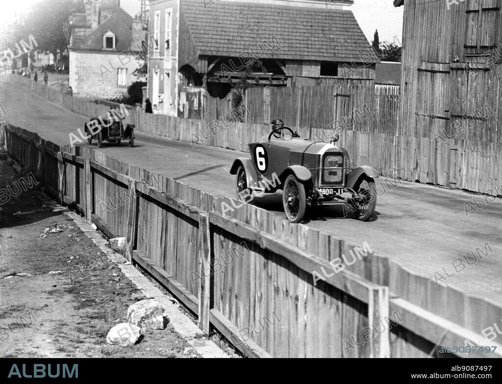 A Mathis car in 1923 , a six-cylinder model , driving along a track.
