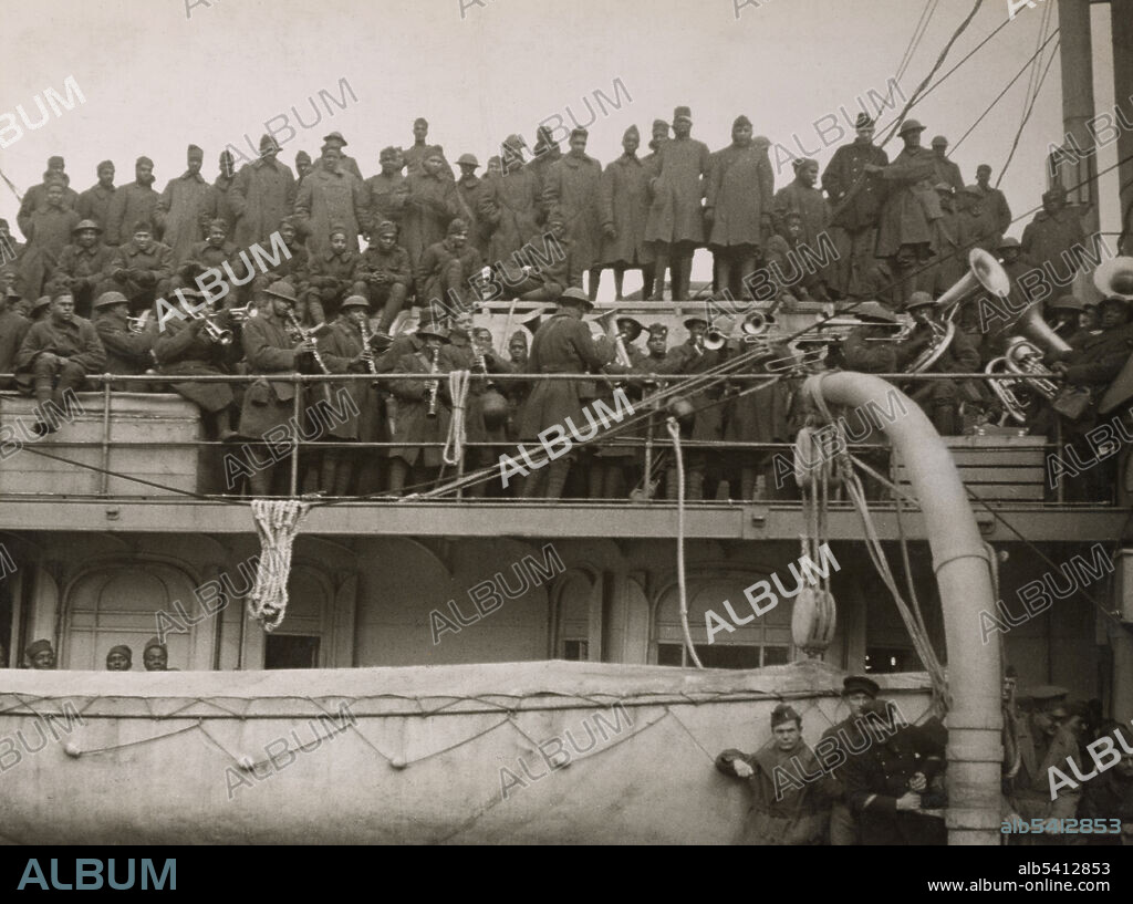 Regiment arrives home from France. The 369th Infantry listening to their band play its last tune before debarking at Hoboken, NJ. James Reese Europe (1881 - 1919) was an African-American ragtime and jazz arranger, composer and bandleader. During WWI he saw combat as a lieutenant with the 369th Infantry and led their regimental band. Western Union Newspaper, February 10, 1919 (cropped and cleaned).