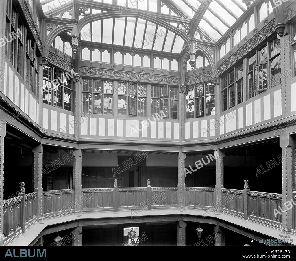 BEDFORD LEMERE AND COMPANY. Liberty and Co department store, Regent Street, London, 1924. Interior of Liberty's newly completed Arts and Crafts Tudor style department store, showing the gallery and light well. This extraordinary building was constructed in 1922-1924 using timbers from HMS 'Hindustan' and HMS 'Impregnable'. It was a remarkable reaction to the early 20th century vogue for stone dressed steel-framed buildings. The building was designed by Edwin Thomas Hall and his son, Edwin Stanley Hall. This photograph was commissioned by Higgs and Hill, builders.