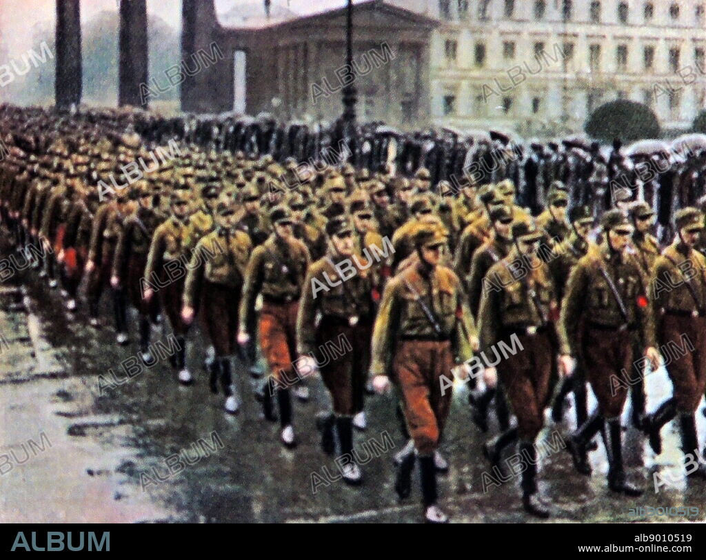 Nazi SA brownshirts march through the Brandenburg Gate in Berlin, Germany circa 1933.