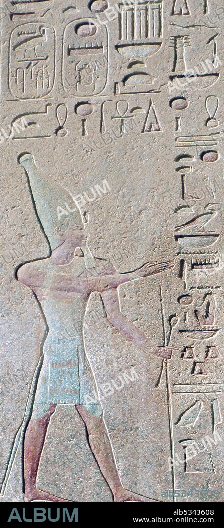 Wall relief (painted) depicting a pharaoh wearing the hedjet or White Crown for Upper Egypt. Temple of Hatshepsut, near Luxor, Egypt. The mortuary temple and tomb dates to the Eighteenth dynasty, and was designed by Senenmut, royal steward and architect of Hatshepsut. It was constructed during the 15th century BC, During the Eighteenth dynasty.