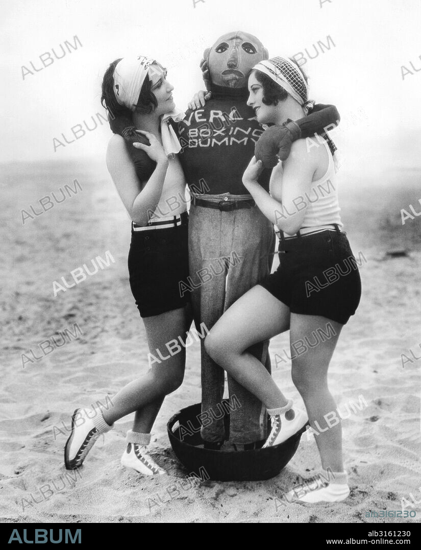 Hollywood, California: June 21, 1927 Actresses Dorothy Sebastian (L) and Joan Crawford (R) vie for the affection of an Everlast boxing dummy.