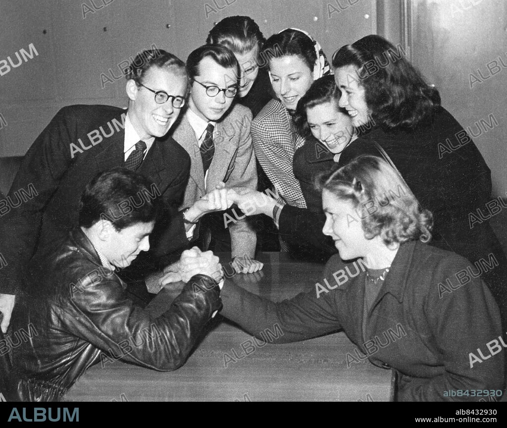1945-10-13.. Inspelning av BRA KARL KAN ALLT.. Frågesporttävling för flickor och pojkar.. Sänt första gången 1945-10-13. Här ses från vänster Rolf Carlsten, Arne Koch, Gustav Öberg, Ted Hagberg, Margaretha Krook, Elisabeth Söderström, Gun Zacharias och Ingrid Bock.. Foto: Sören Hoffman / RiR / SVT / Kod: 5600. RiR sv/v. Mapp: RADIO-Diverse program Mapp 3 Frågesporter 1945 L9. Armbrytning.