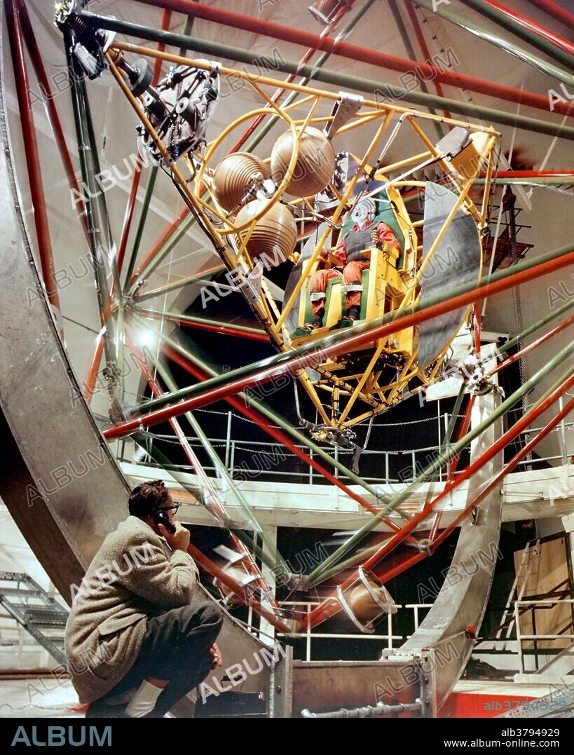 The MASTIF, or Multiple Axis Space Test Inertia Facility, was installed at the Altitude Wind Tunnel at the Lewis Research Center. Three tubular aluminum cages could revolve separately or in combination to give roll, pitch and yaw motions at speeds up to 30 revolutions per minute, greater than those expected in actual space flight. Nitrogen-gas jets, attached to the three cages, controlled the motion. At the center of the innermost cage, the pilot was strapped into a plastic seat, similar to that in the Mercury capsule. His head, body and legs were held in place, leaving only his arms free. The pilot actuated the jets by means of a right-hand control column. By reading instruments mounted at eye level before him, the pilot interpreted his motions and made corrections accordingly. A movement of the column to the right or the left fired the nitrogen-gas jets on the roll cage. In a similar manner, forward or backward movement of the column fired the jets on the pitch cage, and twisting movements actuated jets on the yaw cage.