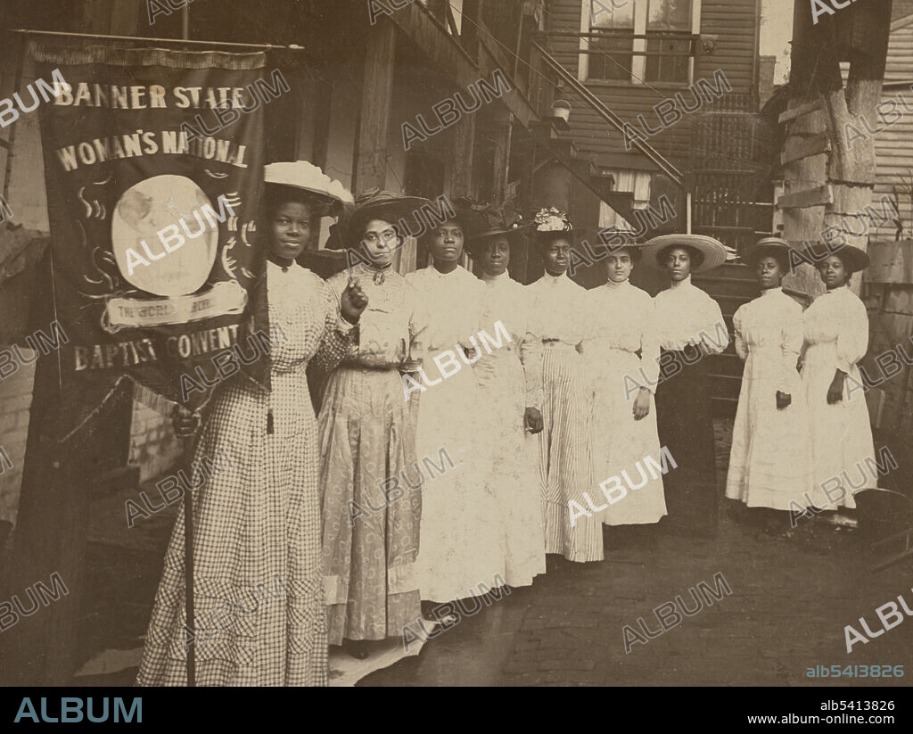 Women standing with Nannie Burroughs holding banner reading, "Banner State Woman's National Baptist Convention". Nannie Helen Burroughs (May 2, 1879 - May 20, 1961) was an African-American educator, orator, religious leader, civil rights activist, feminist, and businesswoman. Her speech "How the Sisters Are Hindered from Helping," at the 1900 National Baptist Convention in Virginia, won her fame and recognition. In 1909, she founded the National Training School for Women and Girls in Washington, DC. Burroughs' objective was at the point of intersection between race and gender. No photographer credited, 1905-1 (cropped and cleaned).