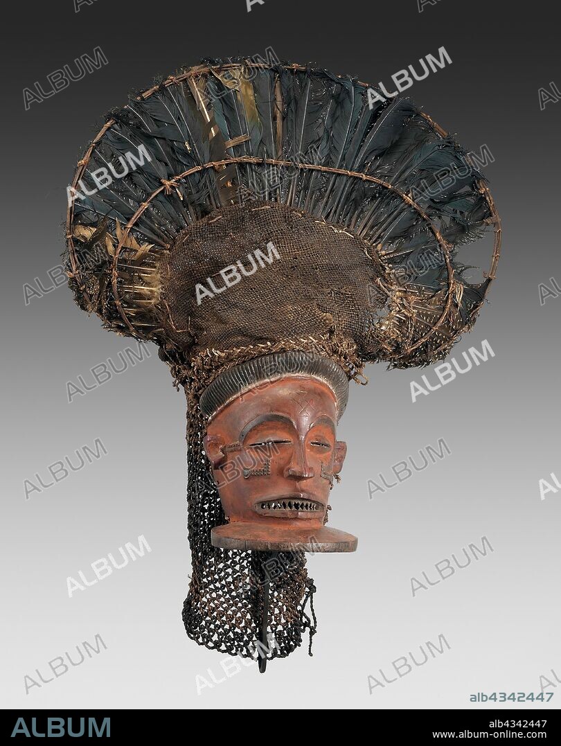 Male Face Mask (Chihongo), Mid–/late 19th century, Chokwe, Angola or Democratic Republic of the Congo, Central Africa, Angola, Wood, raffia, burlap, turaco feathers, guinea fowl feathers, and pigment, 73.7 × 48.3 cm (29 × 19 in.).