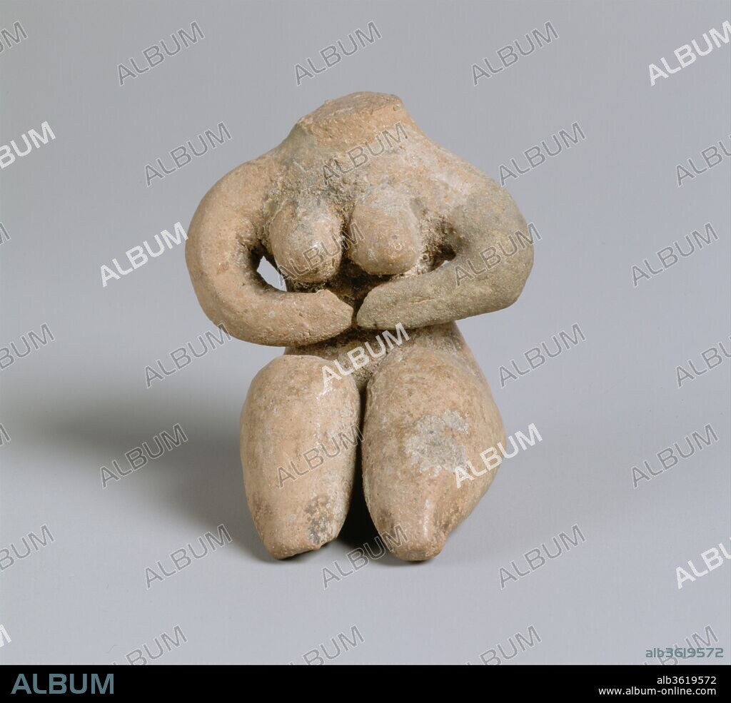 Seated female. Culture: Halaf. Dimensions: H. 5.1 cm, W. 4.5 cm. Date: ca. 5600-5000 B.C..
Distinctive clay female figures like this one were produced at sites belonging to the Halaf culture. This example displays a strong stylization with an emphasis on the sexual features. She sits with her large thighs extended, supporting her breasts with her arms; neither hands nor feet are shown. Her head is missing; in other figures of this type when the head is intact, it is elongated into a large noselike projection but otherwise is featureless. Remains of paint may represent jewelry. The meaning of such representations is unknown but may be connected with fertility. The stylized depiction of the nude female form remained an artistic convention in northern Syria, Anatolia, and the Aegean for several millennia.