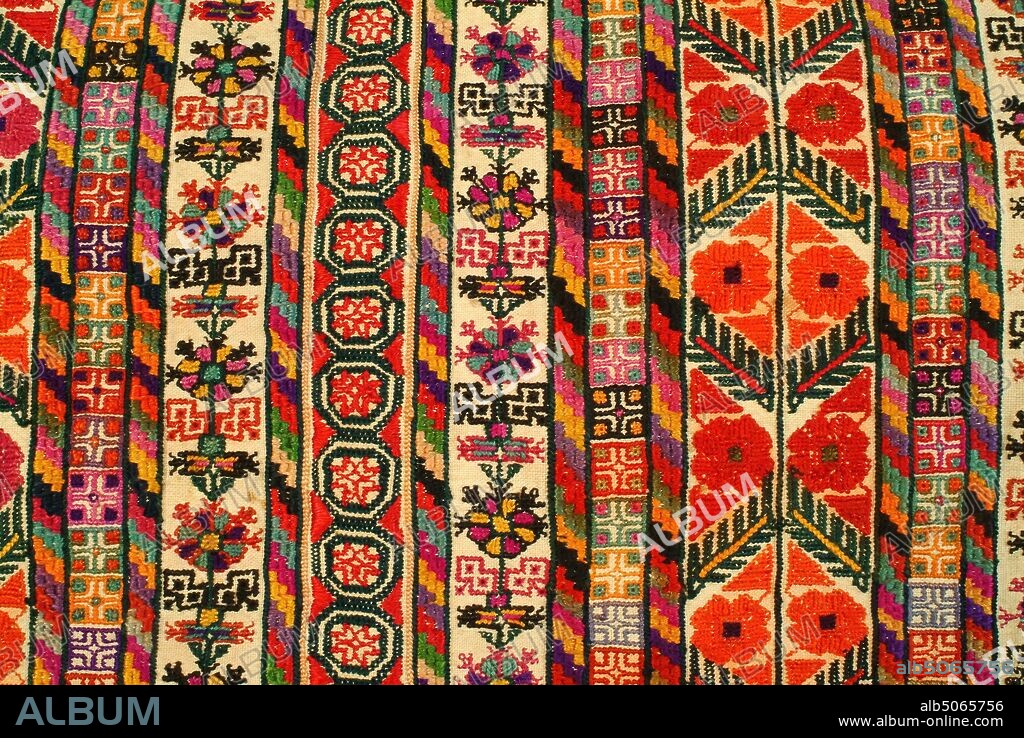 Woman's Dress (Thob), 1800-1900, Palestine, Ramallah, Full length woman's dress made of unbleached cotton embroidered in coloured silks. Pointed triangular hanging sleeves. Small round neck slit to about waist level, edged with quilted cotton and outlined in two rows of black backstitch with a white row inbetween. The slit is bound and faced with pink cotton. Two neck ties are of twisted cotton thread with multi-coloured tassels. Seam across the sleeve and the seam to its sloping side have filling of yellow embroidery in yellow with geometric patterns in crimson, pale blue, pink, orange, black, brown, purple. The sleeves have embroidered borders along the edge and along the seam using above colours. The border edging the lower sleeve is different to edging of upper part. All mainly in fine cross-stitch an employ geometric and plant forms. At front of robe is a wide area of elaborate embroidery, straight sided to hip level, the slopes to a point beneath neck slit. Worked in elaborate vertical strip patterns, again using geometric and plant forms in a wide variety of brilliant glowing colours. Main stitches used are fine cross stitch, half cross stitch, satin stitch. Either side of embroidered panel is a seam worked with an insertion in needle lace stitches.