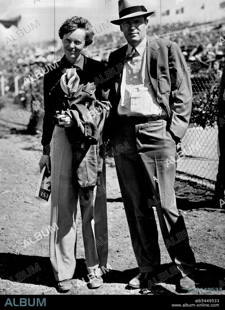 Amelia Earhart and her husband George Palmer Putnam  posing together at an outdoor event.Putnam-No.8. March 04, 1938.