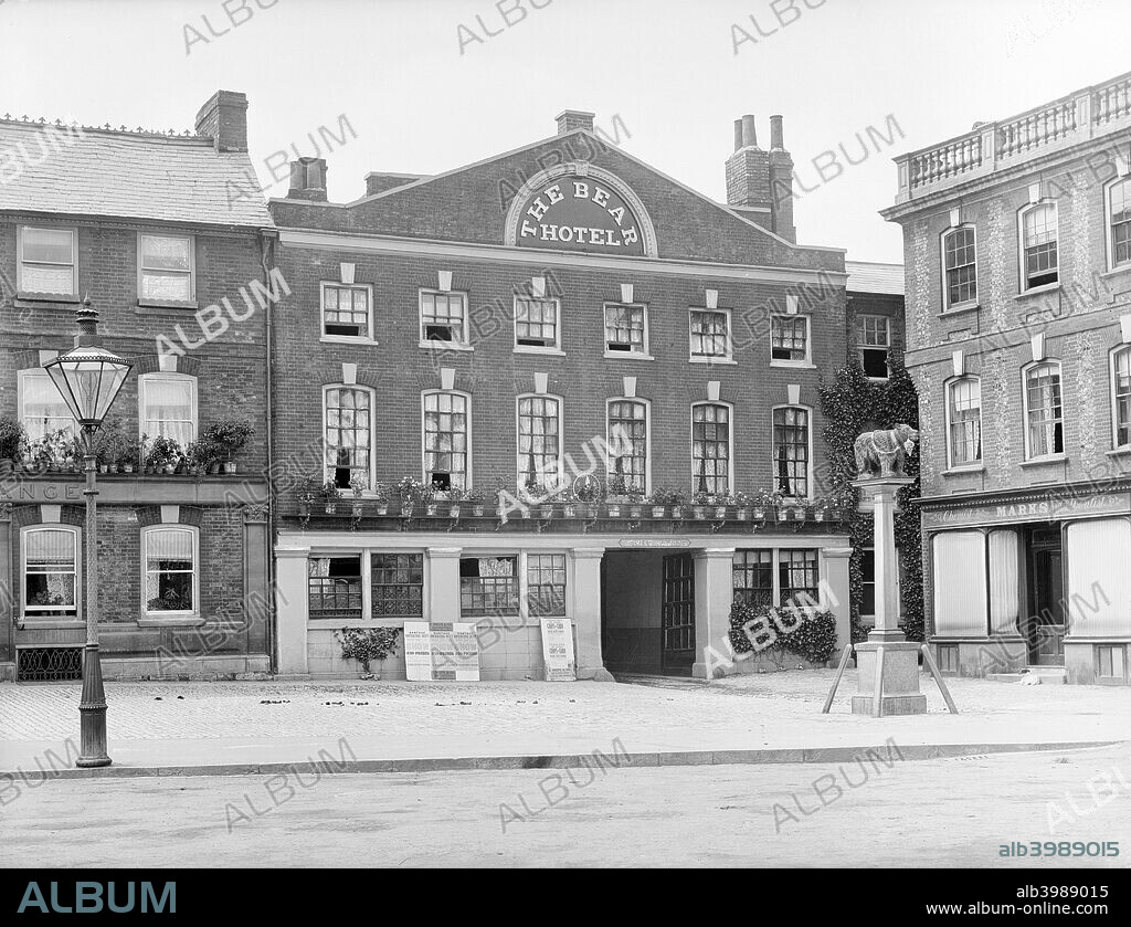 The Bear Hotel, Wantage, Oxfordshire, 1895. The exterior of the front elevation with an inn sign outside, unusually a statue. The Bear is a 16th or 17th century coaching inn, but was remodelled in c1720.