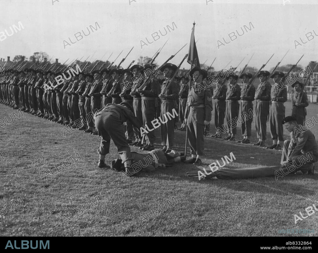 Soldier Faints at Color TroopingIt Was Too Much for this Sergeant when the Royal Melbourne Regiment trooped its Queen's Color to mark Coronation Day on ***** Cricket Ground today. He fainted ***** June 12, 1953.