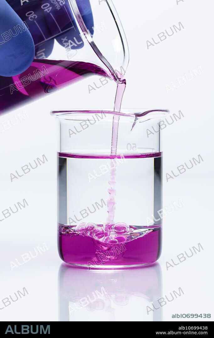 Oxidation of toluene by potassium permanganate, 1 of 2. Violet potassium permanganate(VII) (KMnO4) 0.001M aqueous solution is added to a beaker with toluene (C7H8). Potassium permanganate is a strong oxidising agent. Toluene is a nonpolar aromatic hydrocarbon solvent. The two liquids are immiscible, therefore the reaction occurs only at their interface and thus proceeds slowly, over many hours. Potassium permanganate(VII) is reduced to brown manganese(IV) oxide (MnO2), with possibly some rose-red Mn3+ ions.