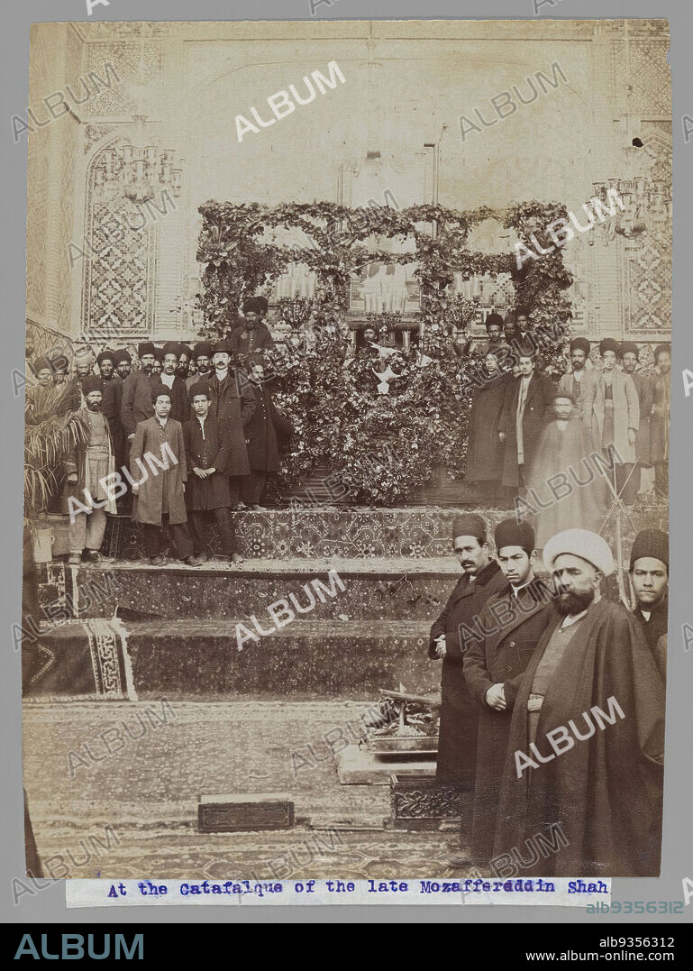 At the Catafalque of the late Mozaffar al-Din Shah, One of 274 Vintage Photographs, Albumen silver photograph, 1906, Qajar, Qajar Period, 8 3/16 x 6 3/16 in., 20.8 x 15.7 cm, arabic, audience, ceremony, death, flowers, funeral, Iran, leader, men, Middle East, mosque, Persia, persian rug, photograph, photography, procession, Shah, stairs, turban.