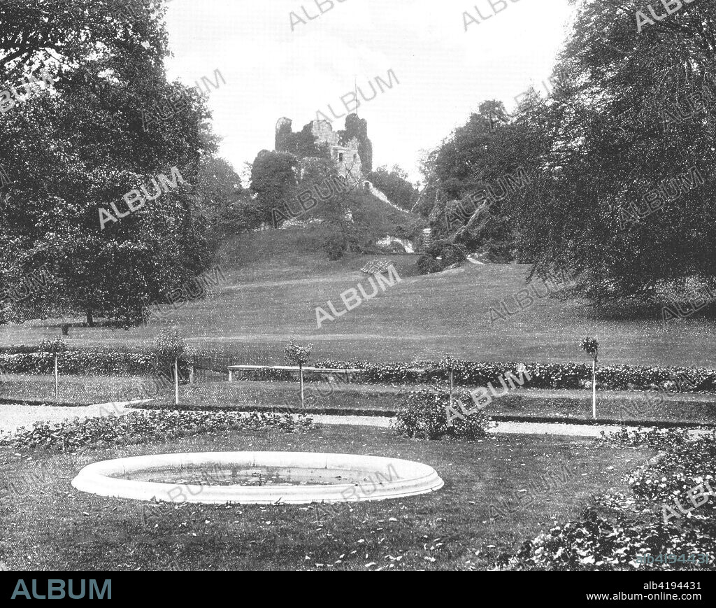 Hawarden Castle, Flintshire, Wales, 1894. Also known as Hawarden 'Old' Castle, the earthwork embankments date back to the Iron Age, with a later Norman Motte-and-bailey castle which was reportedly destroyed and replaced in a short period during the 13th century. From Beautiful Britain; views of our stately homes. [The Werner Company of Chicago, 1894].