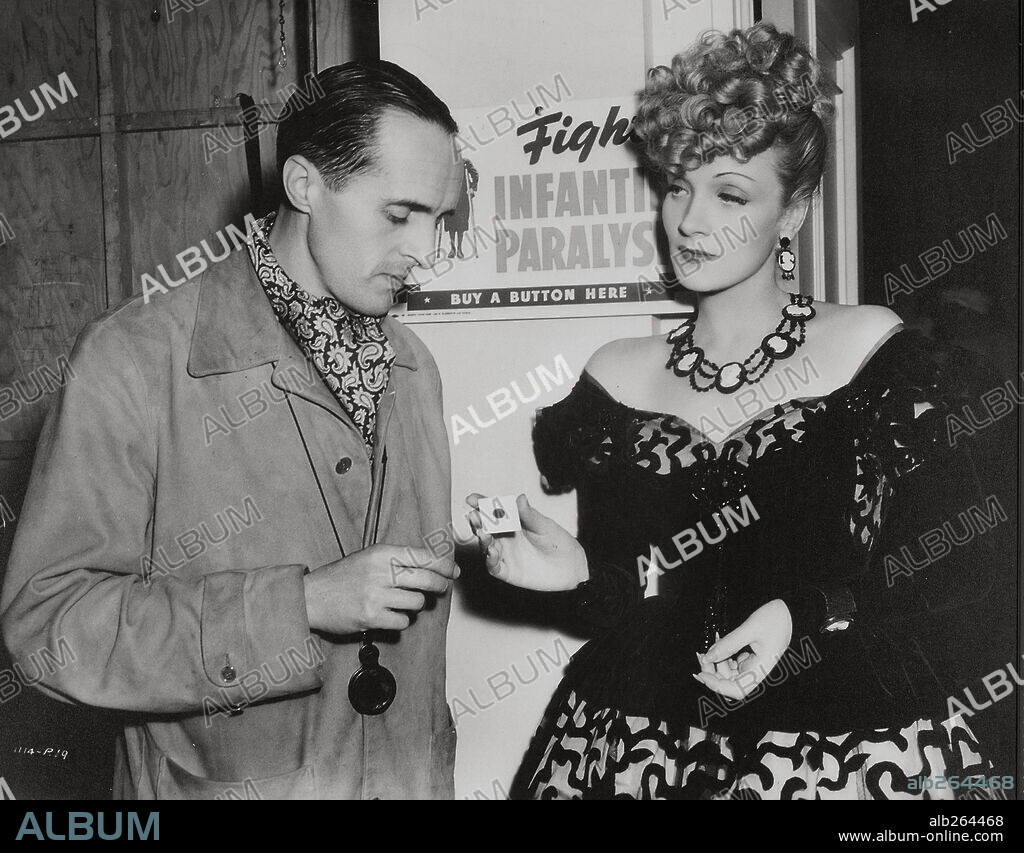 MARLENE DIETRICH and RENE CLAIR in THE FLAME OF NEW ORLEANS, 1941, directed by RENE CLAIR. Copyright UNIVERSAL PICTURES.