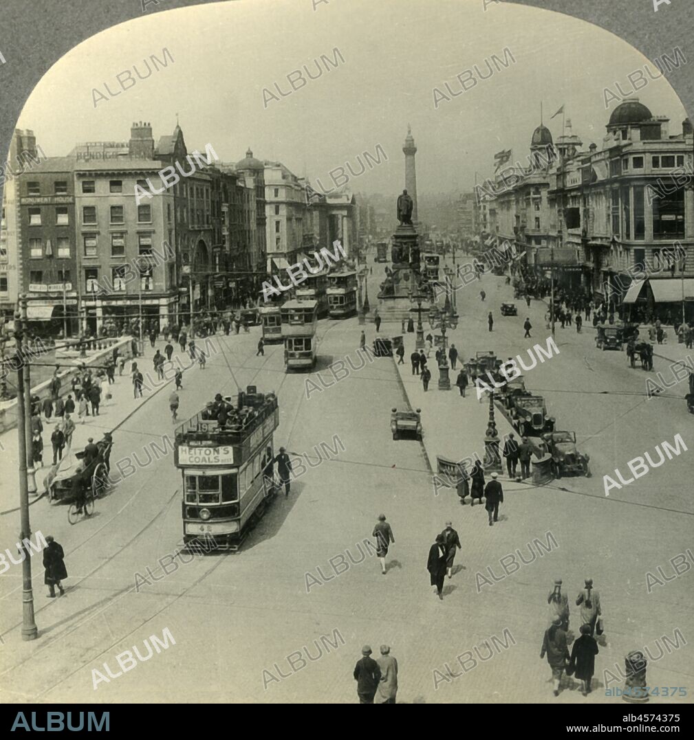'The O'Connell Monument and the Nelson Pillar, O'Connell Street, Dublin, Ireland', c1930s. Memorial to Daniel O'Connell by John Henry Foley and Nelson's Pillar  damaged by explosives in 1966 on O'Connell Street in Dublin.  From "Tour of the World". [Keystone View Company, Meadville, Pa., New York, Chicago, London].