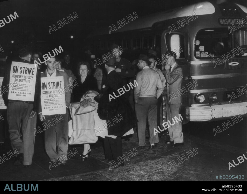 Picket Bus Terminal -- As A  picket line (left) formed early this morning at the Greyhound Bus Terminal here, a bus (right), coming into Washington from the North, discharges its passengers at the curb. Efforts to avert a walkout failed just before the midnight deadline. November 1, 1945. (Photo by AP Wirephoto).