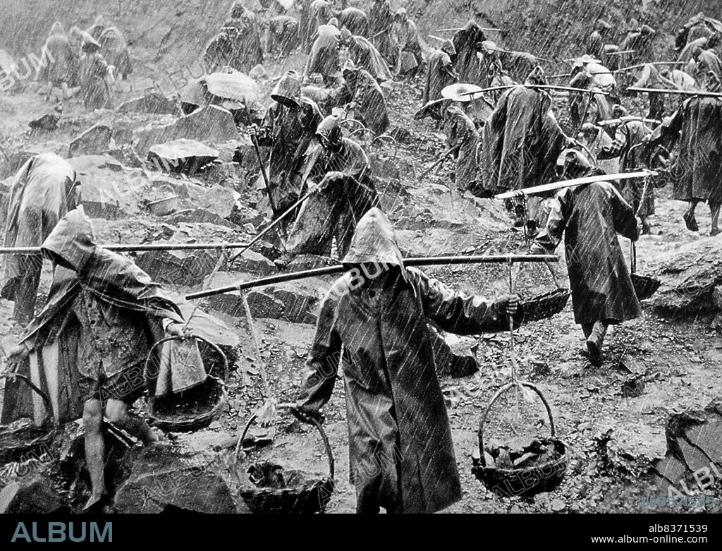 China: A team of workers labouring in a stone quarry in
