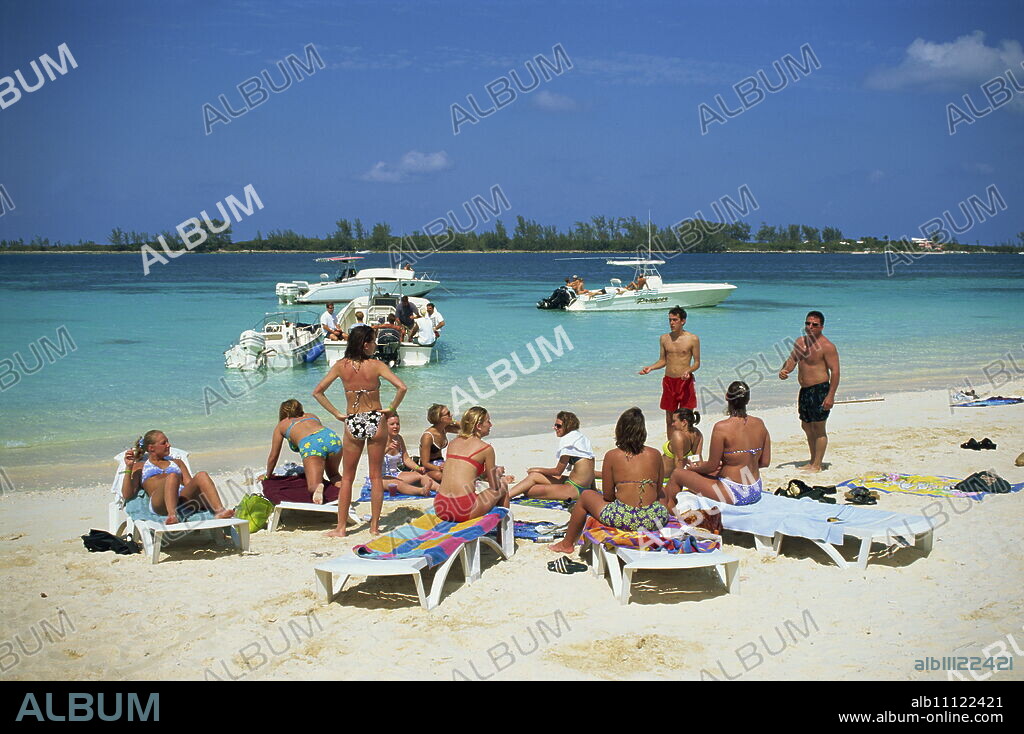 Group of tourists on beach, Western Esplanade, Nassau, Bahamas, West Indies, Central America.