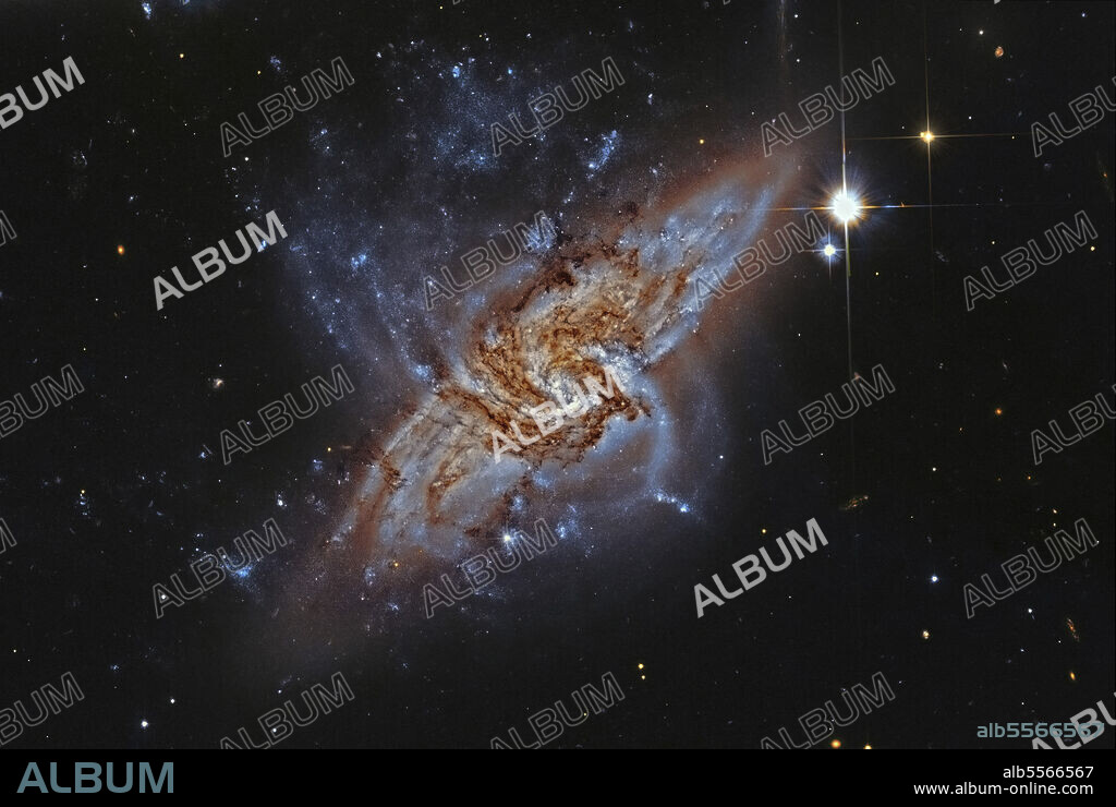 NGC 3314, a pair of overlapping spiral galaxies in the constellation Hydra.