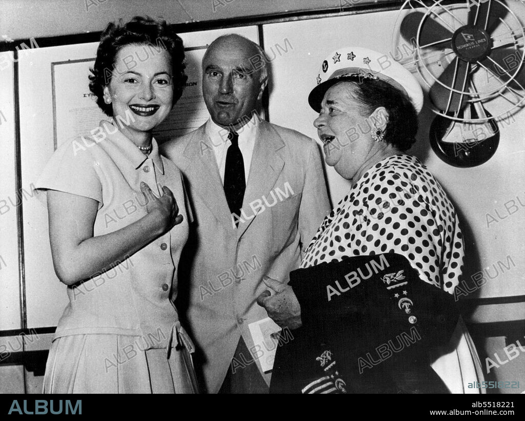 With Elsa in Command - Elsa Maxwell, wearing comic Naval Uniform, welcomes film star Olivia De Havilland aboard the yacht at Venice ...Maxwell, one of the ***** are sailing from Venice to Greek and the Green Islands ... The guests include people and film stars from many Parts of the world ...People in the know Estimate that the parts course is going to cost at least ***** some party ... . August 30, 1955. (Photo by Paul Popper).