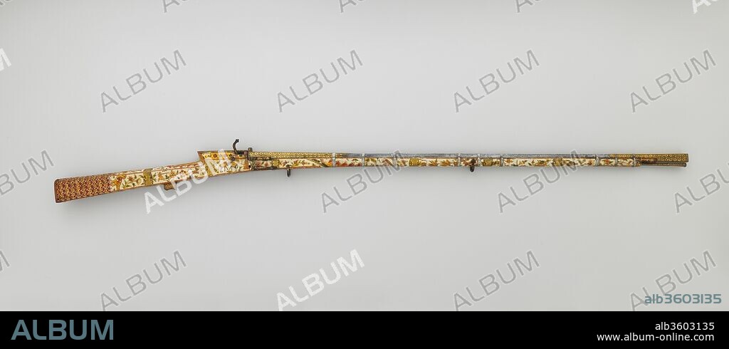 Matchlock Gun. Culture: Indian, Rajasthan or Lahore. Dimensions: L. 61 5/8 in. (156.4 cm); L. of barrel 42 7/8 in. (108.8 cm); Cal. .44 in. (11.0 mm); Wt. 8 lb. (3631 g). Date: late 18th-early 19th century.
Firearms were used in India starting in the fifteenth century and the matchlock remained the preferred firearms mechanism until about 1830. This sporting gun is distinctive for its delicately painted stock covered with hunting scenes, birds and other animals, and landscapes. The gold-damascened barrel is a masterpiece of forging, having both a square cross section and a square bore. It is signed by the smith Haji Sha'ban, who signed two other barrels on guns captured by the British at Lahore, in northwest India (now Pakistan), in the nineteenth century.