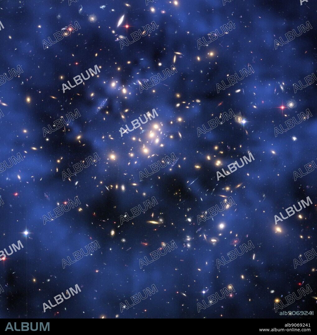 Hubble composite image showing the ring of dark matter in the galaxy cluster Cl 0024+17. The ring-like structure is evident in the blue map of the cluster's dark matter distribution. The map was derived from Hubble observations of how the gravity of the cluster Cl 0024+17 distorts the light of more distant galaxies, an optical illusion called gravitational lensing. Although astronomers cannot see dark matter, they can infer its existence by mapping the distorted shapes of the background galaxies. astronomers don't know what dark matter is made of, they hypothesize that it is a type of elementary particle that pervades the universe. The map is superimposed on a Hubble Advanced Camera for Surveys image of the cluster taken in November 2004.