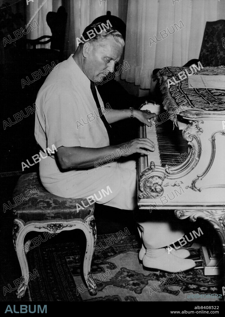 Pianist Tito Wants "Optimistic" Music -- President Josip Broz Tito of Yugoslavia playing his grand Pianoforte recently. Picture received from Belgrade today May 17th.President Josip Broz Tito, himself an accomplished pianist has advised Yugoslav musicians to soft Pedal Jazz and compose instead "Optimistic" tunes reflecting the country's development."Jazz music does not comply with our character and our recently" Tito told musicians at the second Congress of Yugoslav musicians recently. May 17, 1953. (Photo by Associated Press Photo).