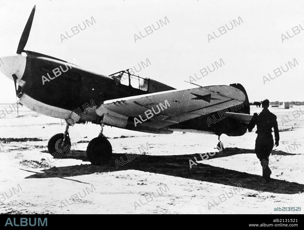 A russian pilot about to enter an american fighter plane (p-41?) that was just delivered, complete with red star insignia, to the red air force at an assembly center for u, s, lend-lease aircraft in iran.