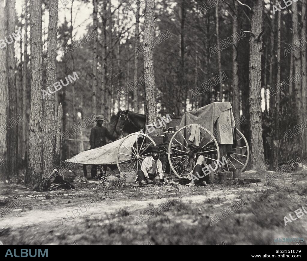 Petersburg, Virginia:  1864 Civil War photographer Mathew Brady seated, left, with his wagon and equipment used to photograph scenes on the battlefield.