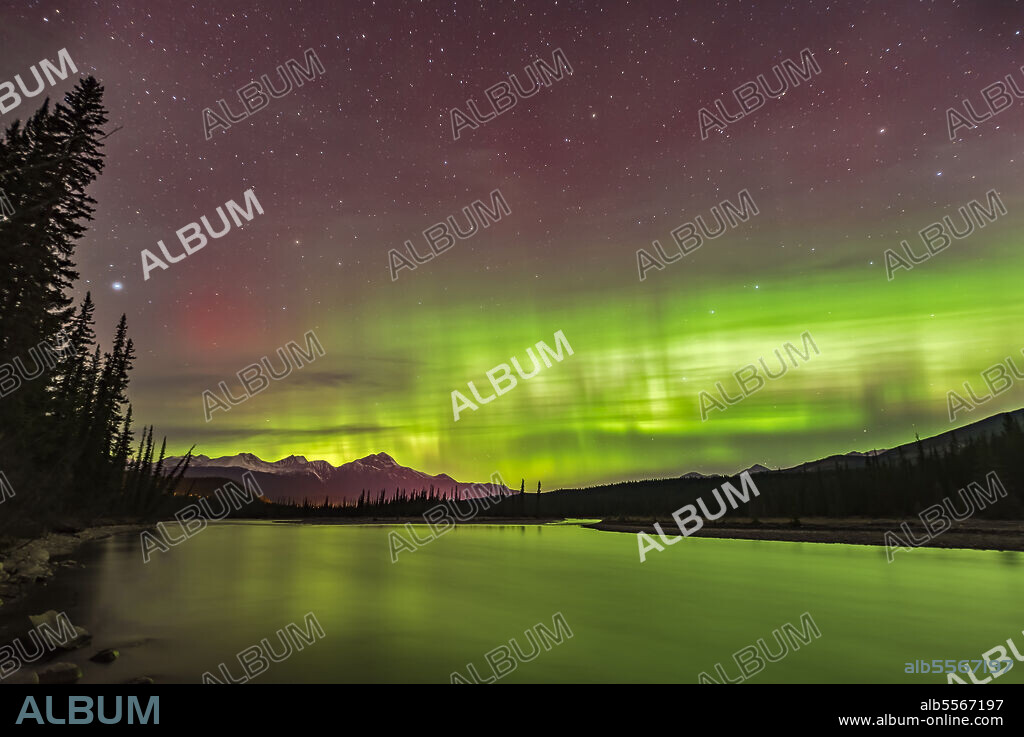 The northern lights over the Athabasca River in Jasper National Park, Alberta, Canada, on October 22/23 at about 1:30 am. Pyramid Mountain is at left near the town of Jasper. Vega is the bright star at left; the Big Dipper is at right.