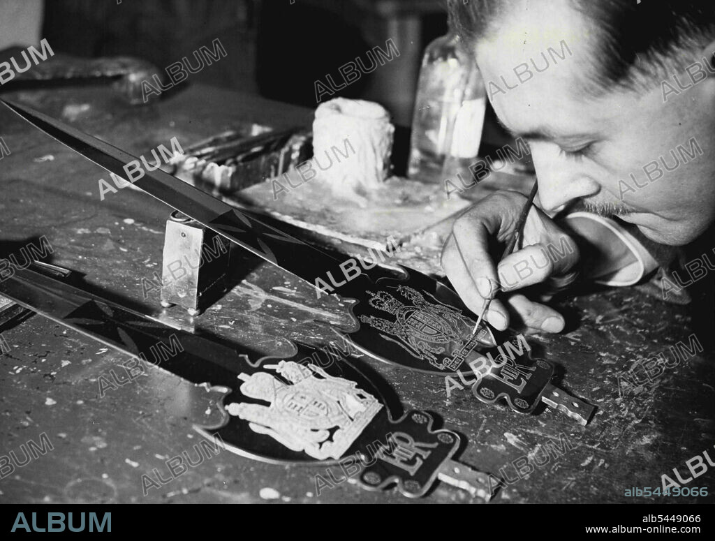 Ceremonial Swords for The Coronation -- Mr. Charles Webb, 22 years in the business, is seen etching and embossing a partizan for St. James Palace Yeomanry of the Guard. Sword outters are now busy making officers' ceremonial swords or refurbishing old ones in preparation for the Coronation. The Wilkinson Sword Company, of Acton, which still carries on this work, at present has orders for 2,000. This is the largest order of its kind since the Coronation of 1937. At present the demand for swords averages about 100 a week, but after the Coronation, and the royal visit to Australia and New Zealand, it is expected to drop to about 50 a week. This firm has had the market largely to itself. The new swords follow about a dozen different patterns. They are being made for the Household Cavalry, the Yeomen of the Guard, the R.A.F. and others. Many of the existing swords including those belonging to the Yeomen of the Guard, are being sent to the firm to be brought 'up to date'. January 15, 1953. (P.