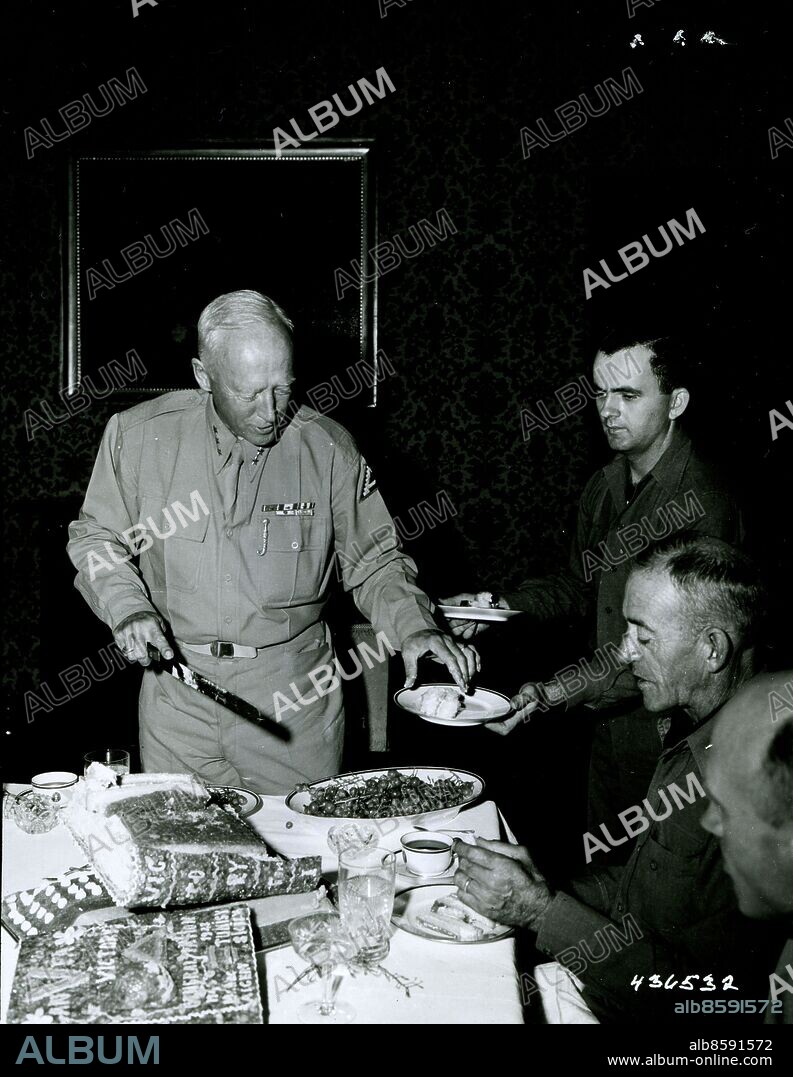 March 18, 1944 - Lt. Gen. George S. Patton, Jr., CG of the 7th Army giving the first piece of the victory cake celebrating victory in Sicily to Col. Paddy Flint.